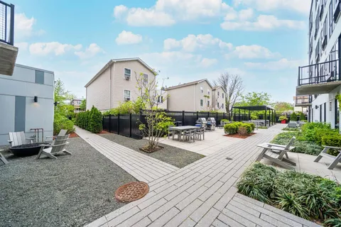 a view of a house with backyard and sitting area
