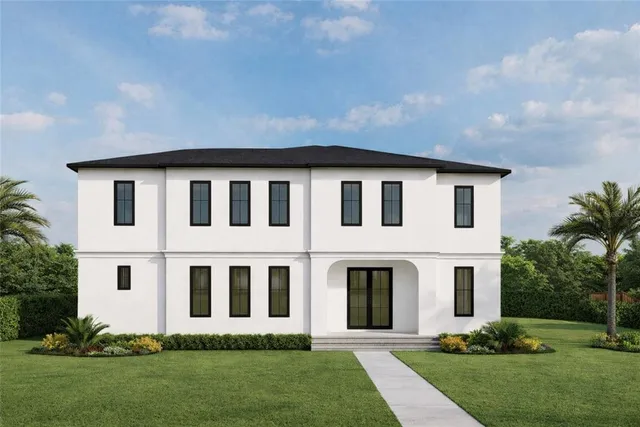 a large white house with a yard and plants