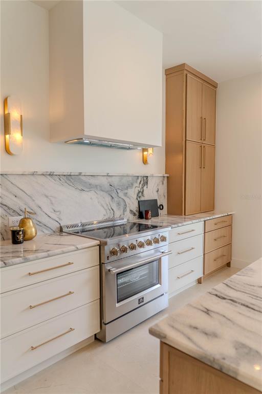 4502 South Shamrock Road Tampa, FL 33611 - Photo 15 of 41 a kitchen with granite countertop white cabinets and white appliances