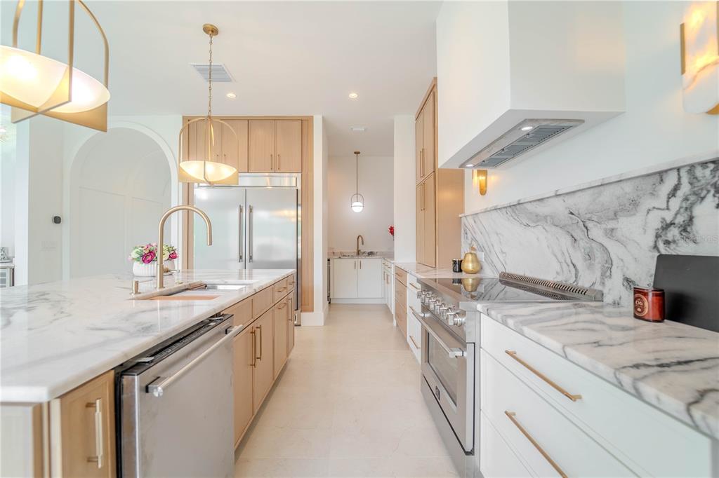 4502 South Shamrock Road Tampa, FL 33611 - Photo 18 of 41 a kitchen with a sink stove and cabinets