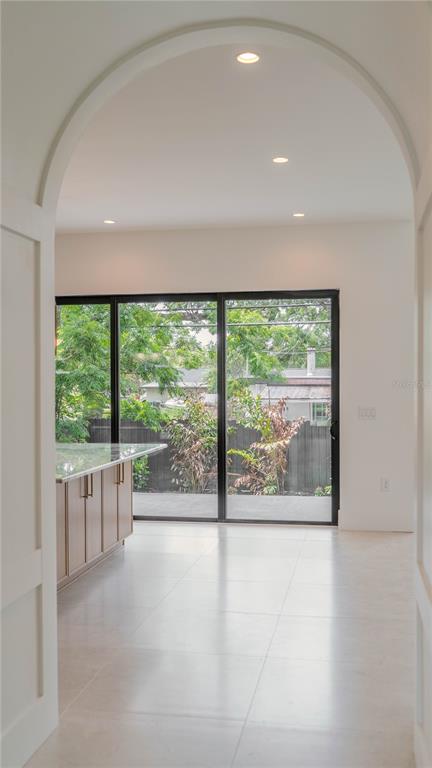 4502 South Shamrock Road Tampa, FL 33611 - Photo 24 of 41 a view of a big room with wooden floor and doors