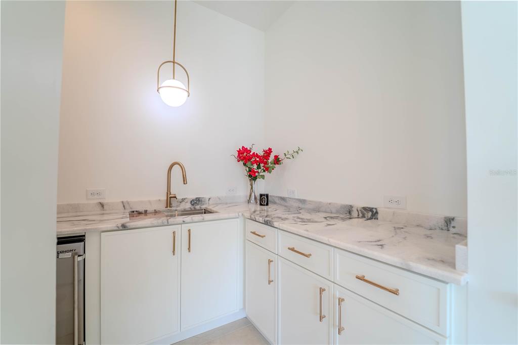 4502 South Shamrock Road Tampa, FL 33611 - Photo 25 of 41 a bathroom with a granite countertop sink and a mirror
