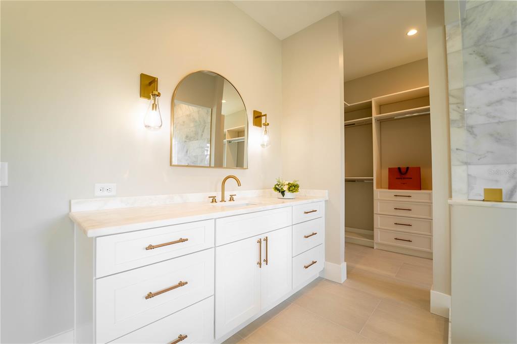 4502 South Shamrock Road Tampa, FL 33611 - Photo 35 of 41 a bathroom with a double vanity sink and mirror