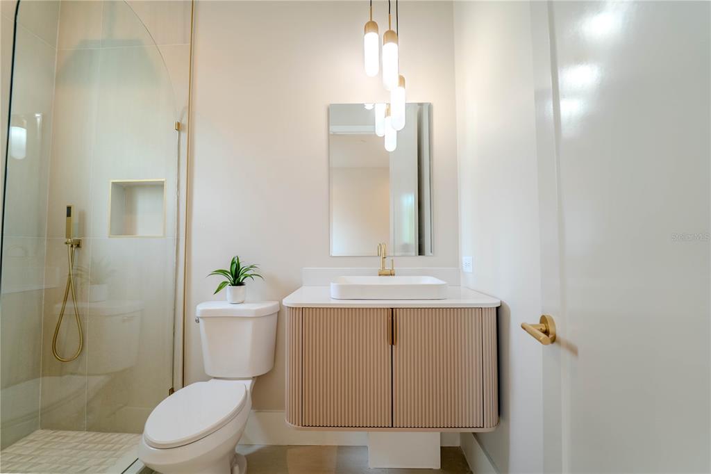 4502 South Shamrock Road Tampa, FL 33611 - Photo 40 of 41 a bathroom with a sink a toilet and shower