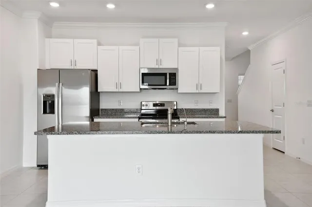a kitchen with granite countertop a sink and a granite counter tops