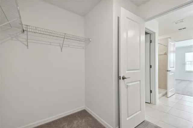 a view of a swimming pool with outdoor seating and plants