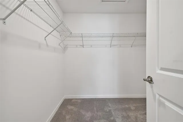 a view of a swimming pool with lawn chairs