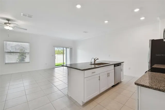 a kitchen with stainless steel appliances granite countertop a sink and a stove