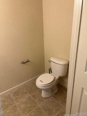 a white toilet sitting next to a shower