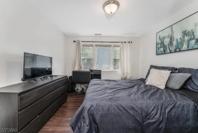 a bedroom with a bed and a flat screen television