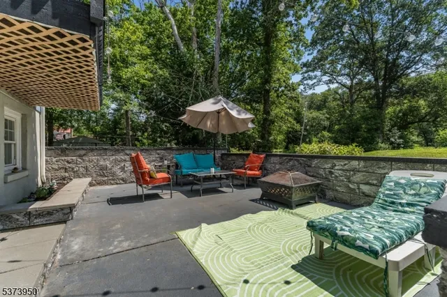 a view of backyard with seating space and trees