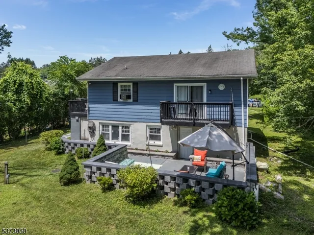 an aerial view of a house with swimming pool and garden