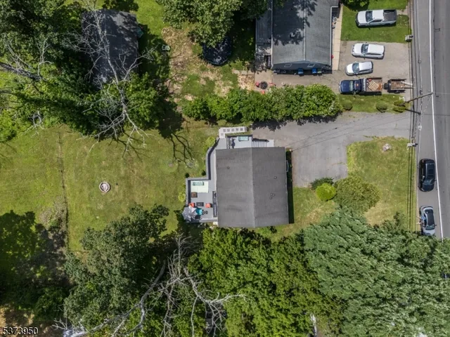 an aerial view of a house with a yard and lake view