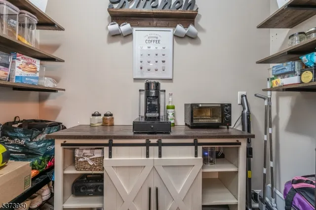 a view of a kitchen with stainless steel appliances granite countertop a stove and a refrigerator