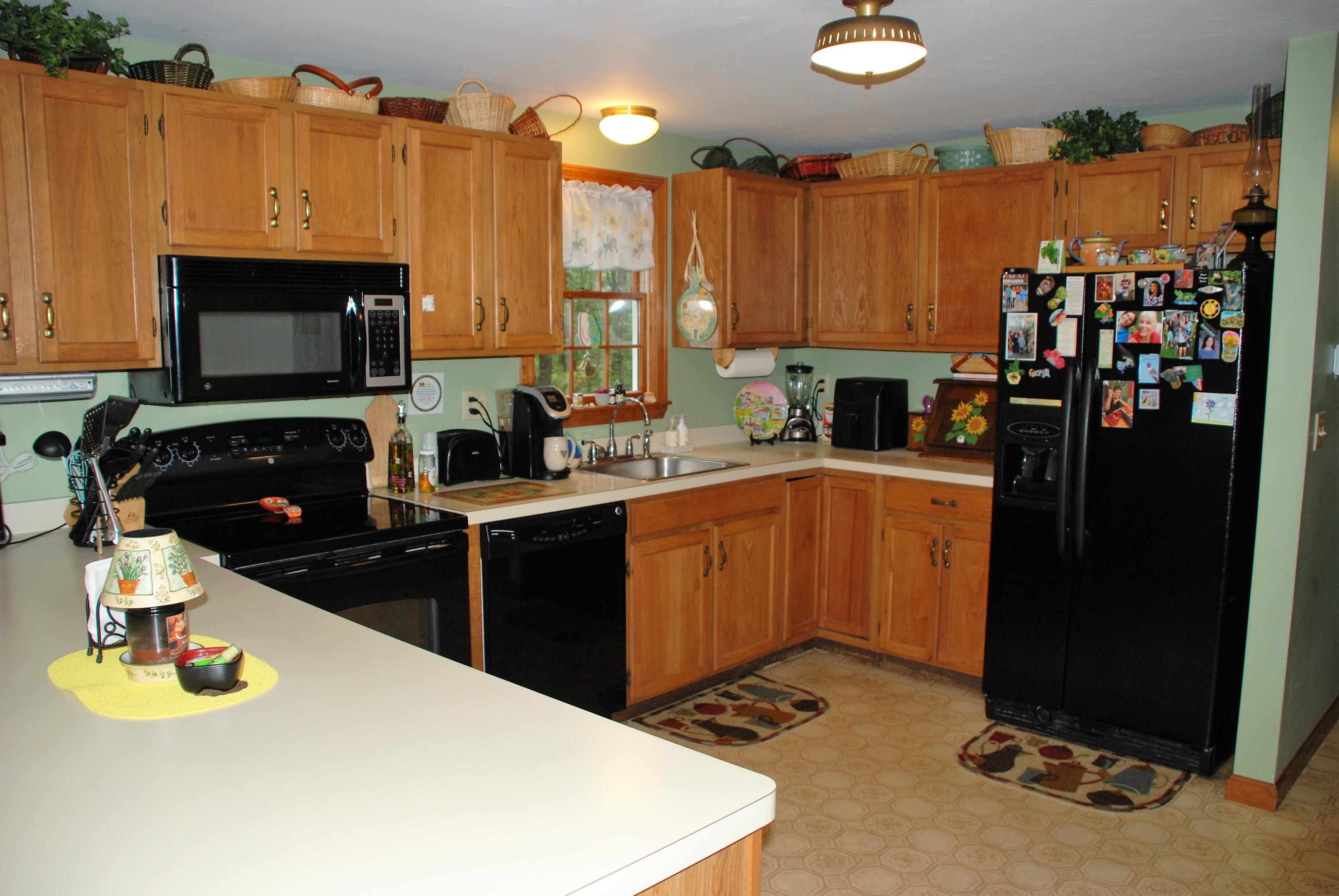 16 Skipjack Lane Hyannis, MA 02601 - Photo 12 of 39 a kitchen with a refrigerator and a stove top open