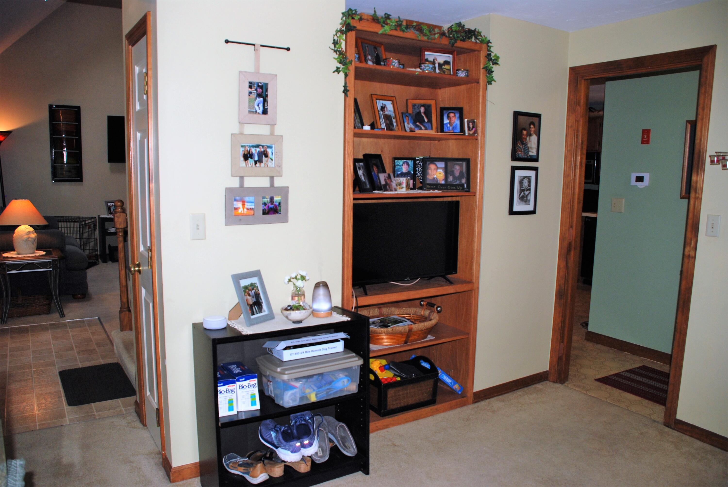 16 Skipjack Lane Hyannis, MA 02601 - Photo 22 of 39 a room with furniture a flat screen tv and a book shelf