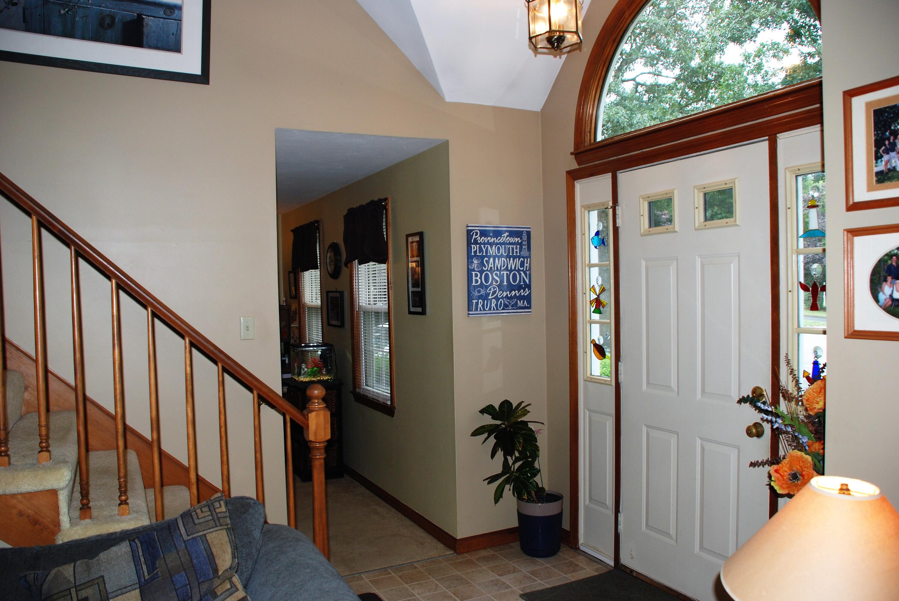 16 Skipjack Lane Hyannis, MA 02601 - Photo 5 of 39 a view of an entryway with wooden floor and stairs