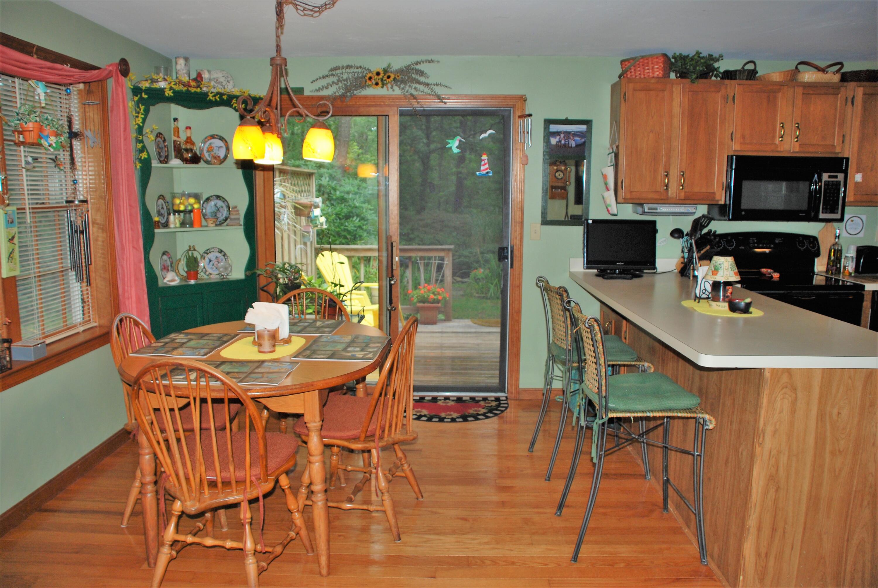 16 Skipjack Lane Hyannis, MA 02601 - Photo 8 of 39 a view of a dining room with furniture a chandelier and wooden floor