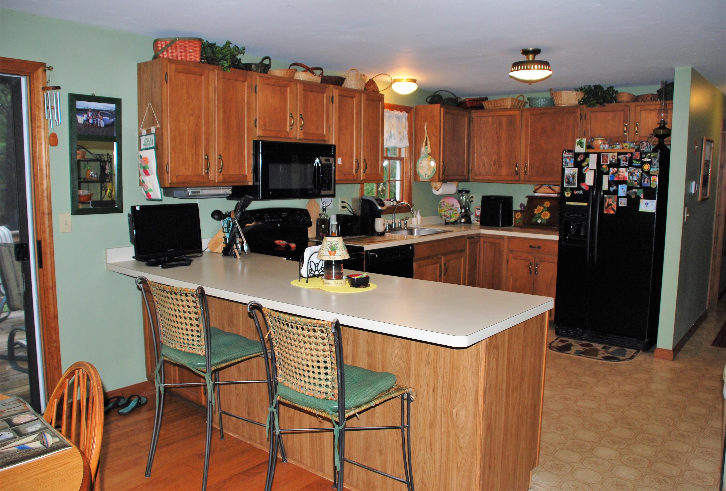 16 Skipjack Lane Hyannis, MA 02601 - Photo 9 of 39 a kitchen that has a table chairs and a refrigerator