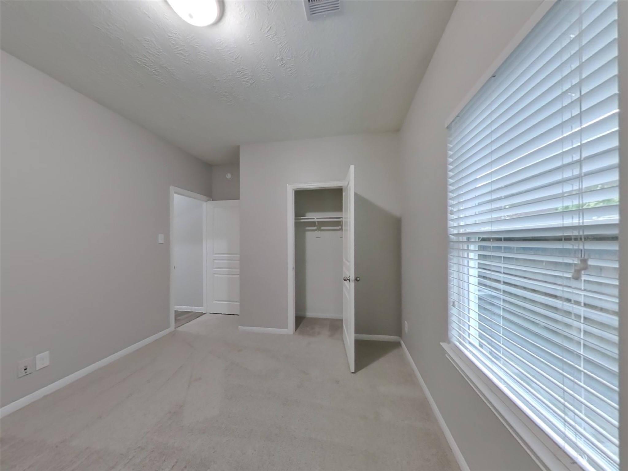210 Pequin Road Crosby, TX 77532 - Photo 14 of 18 a view of an empty room with closet and a window
