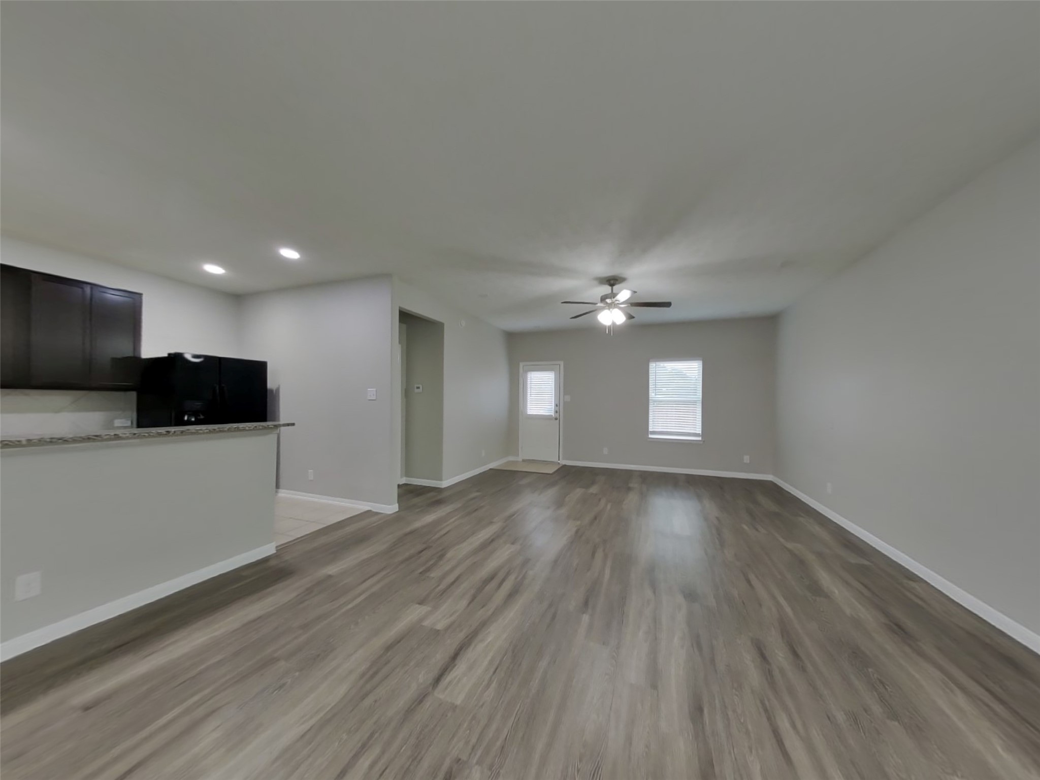 210 Pequin Road Crosby, TX 77532 - Photo 2 of 18 a view of an empty room with window fireplace and a ceiling fan