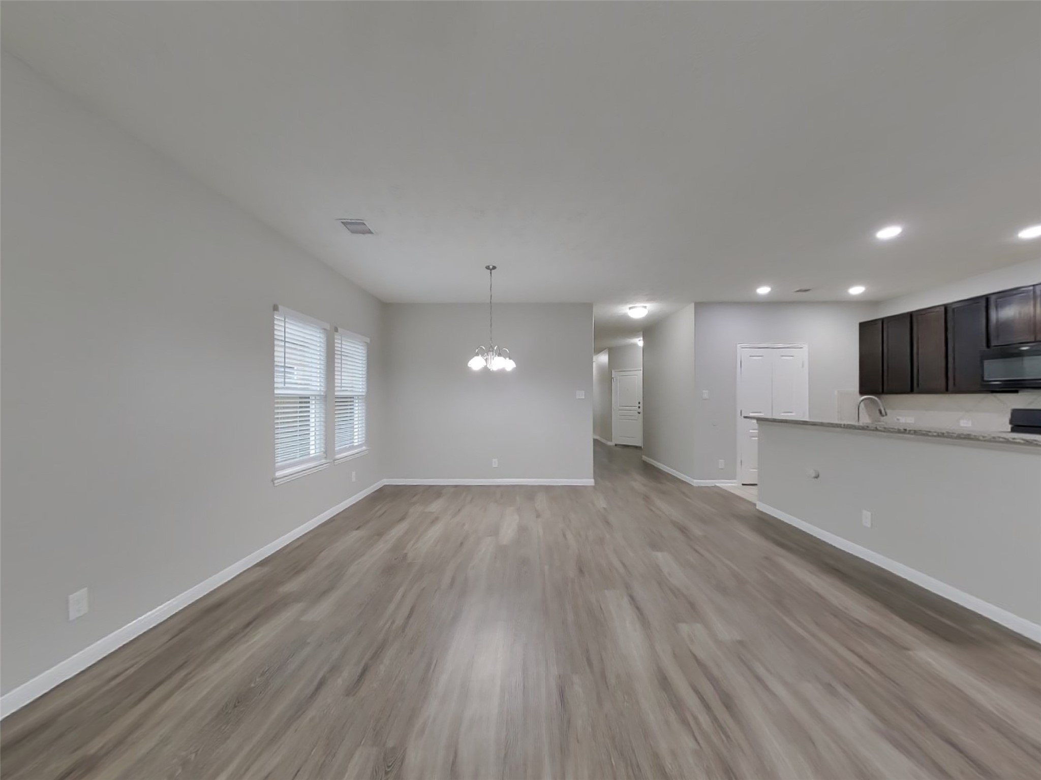 210 Pequin Road Crosby, TX 77532 - Photo 3 of 18 a view of an empty room with wooden floor and a window