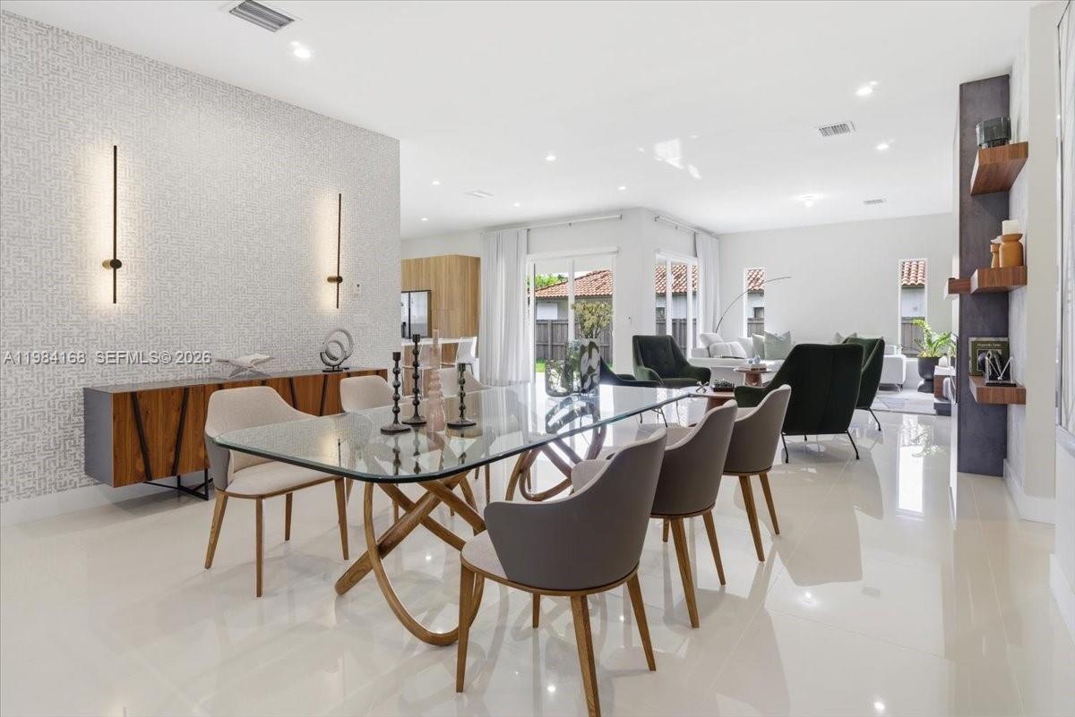21205 Ingraham Ave Road Cutler Bay, FL 33189 - Photo 12 of 42 a view of a dining room with furniture and wooden floor
