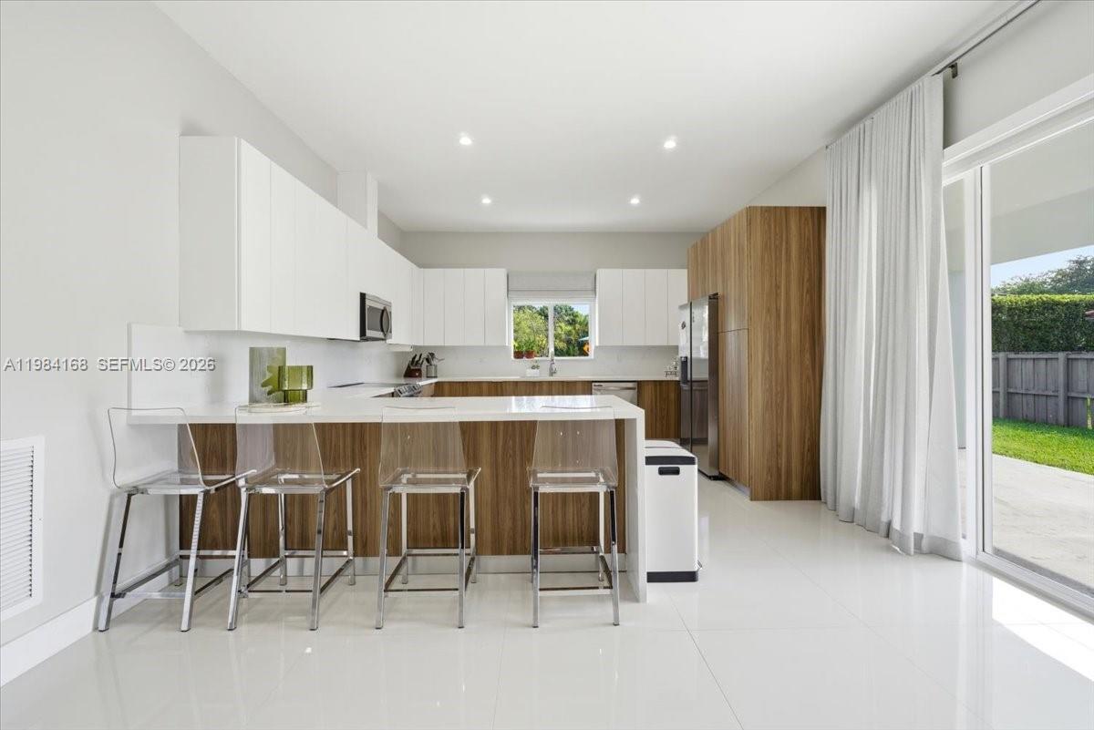 21205 Ingraham Ave Road Cutler Bay, FL 33189 - Photo 17 of 42 a kitchen with stainless steel appliances a refrigerator and microwave