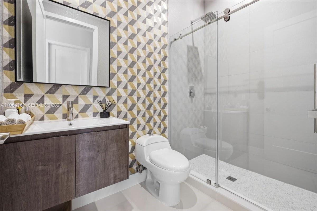 21205 Ingraham Ave Road Cutler Bay, FL 33189 - Photo 21 of 42 a bathroom with a toilet a sink and shower