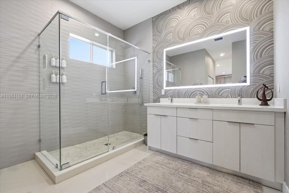 21205 Ingraham Ave Road Cutler Bay, FL 33189 - Photo 27 of 42 a bathroom with a shower sink and mirror