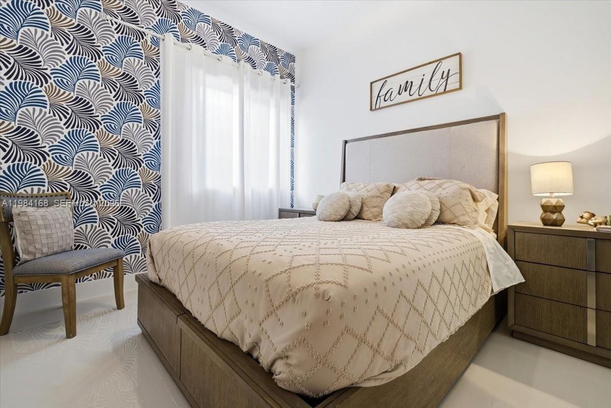 21205 Ingraham Ave Road Cutler Bay, FL 33189 - Photo 29 of 42 a bedroom with a bed and a lamp with window