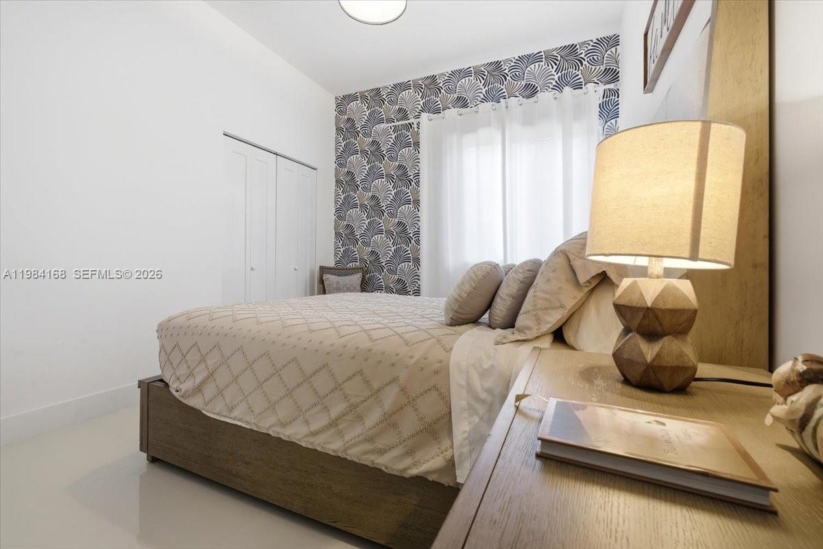 21205 Ingraham Ave Road Cutler Bay, FL 33189 - Photo 30 of 42 a bedroom with a bed and window