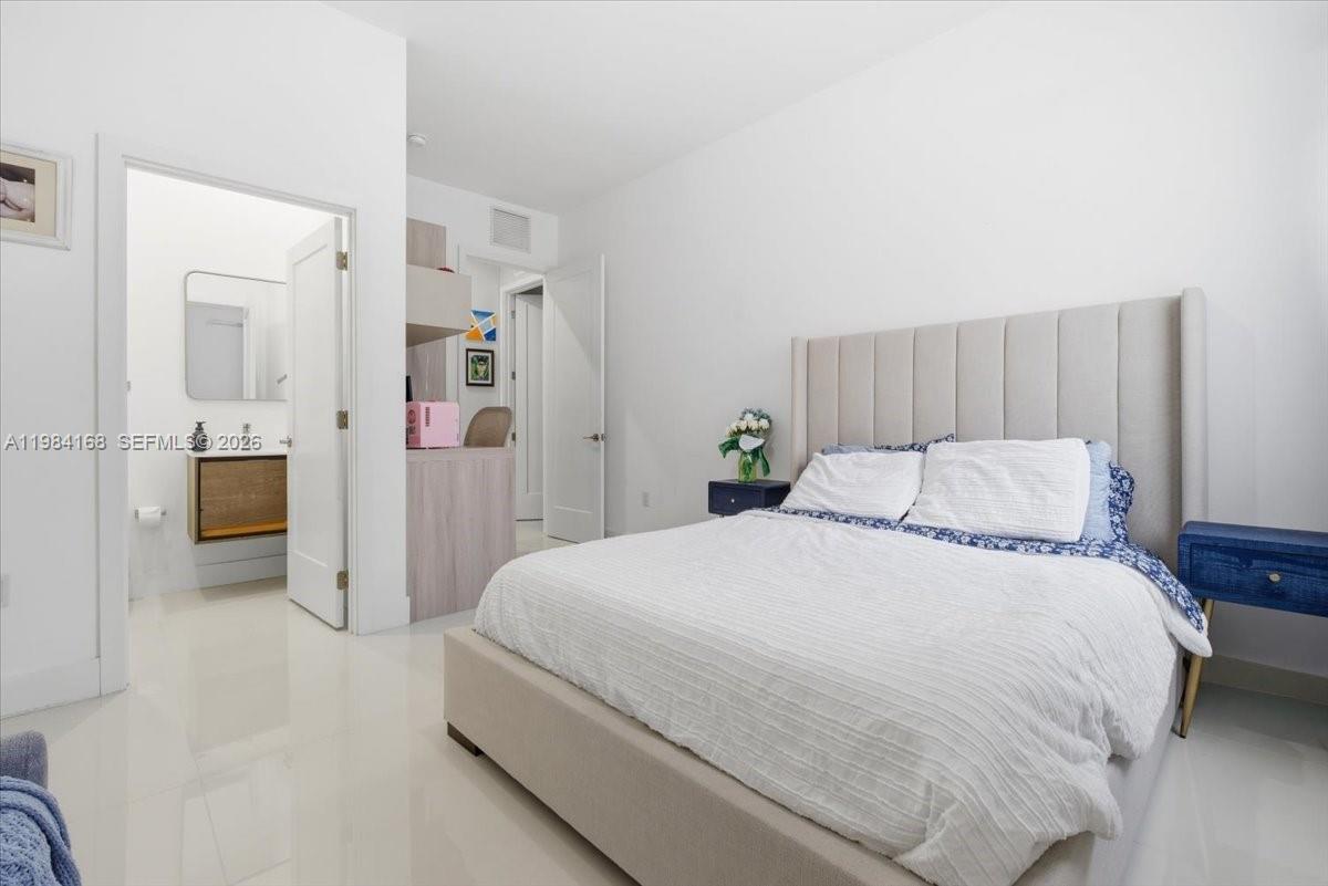 21205 Ingraham Ave Road Cutler Bay, FL 33189 - Photo 34 of 42 a spacious bedroom with a bed and a couch