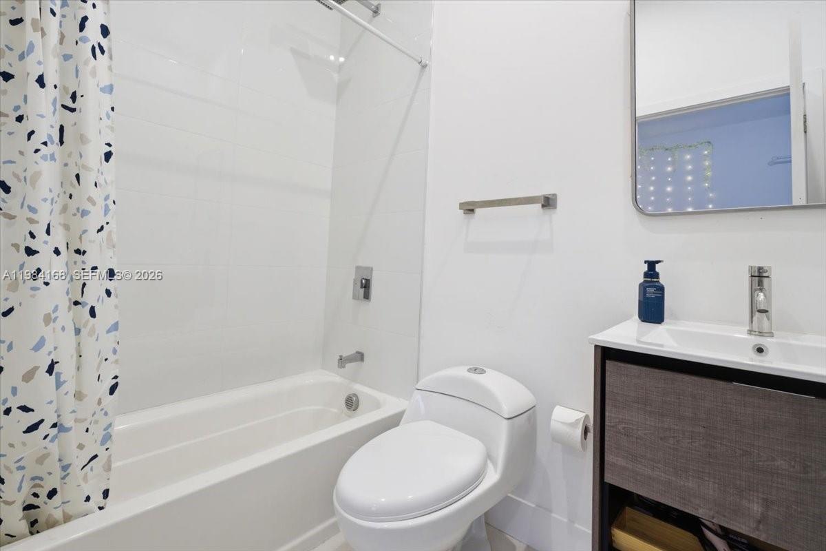 21205 Ingraham Ave Road Cutler Bay, FL 33189 - Photo 36 of 42 a white toilet sitting next to a bath tub