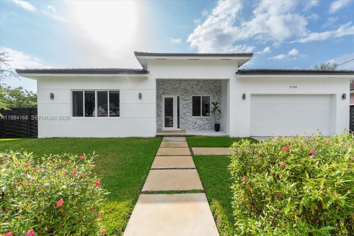 21205 Ingraham Ave Road Cutler Bay, FL 33189 - Photo 4 of 42 a front view of a house with garden