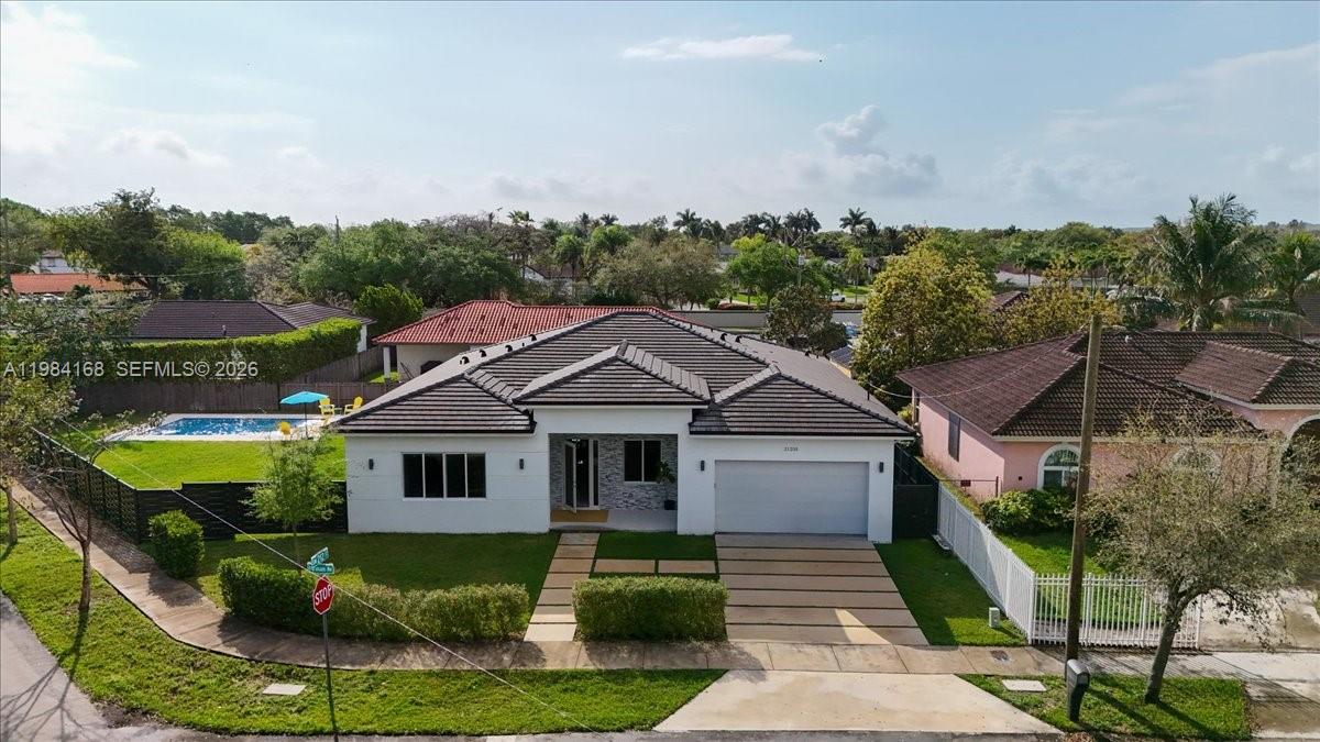 21205 Ingraham Ave Road Cutler Bay, FL 33189 - Photo 5 of 42 a front view of a house with garden