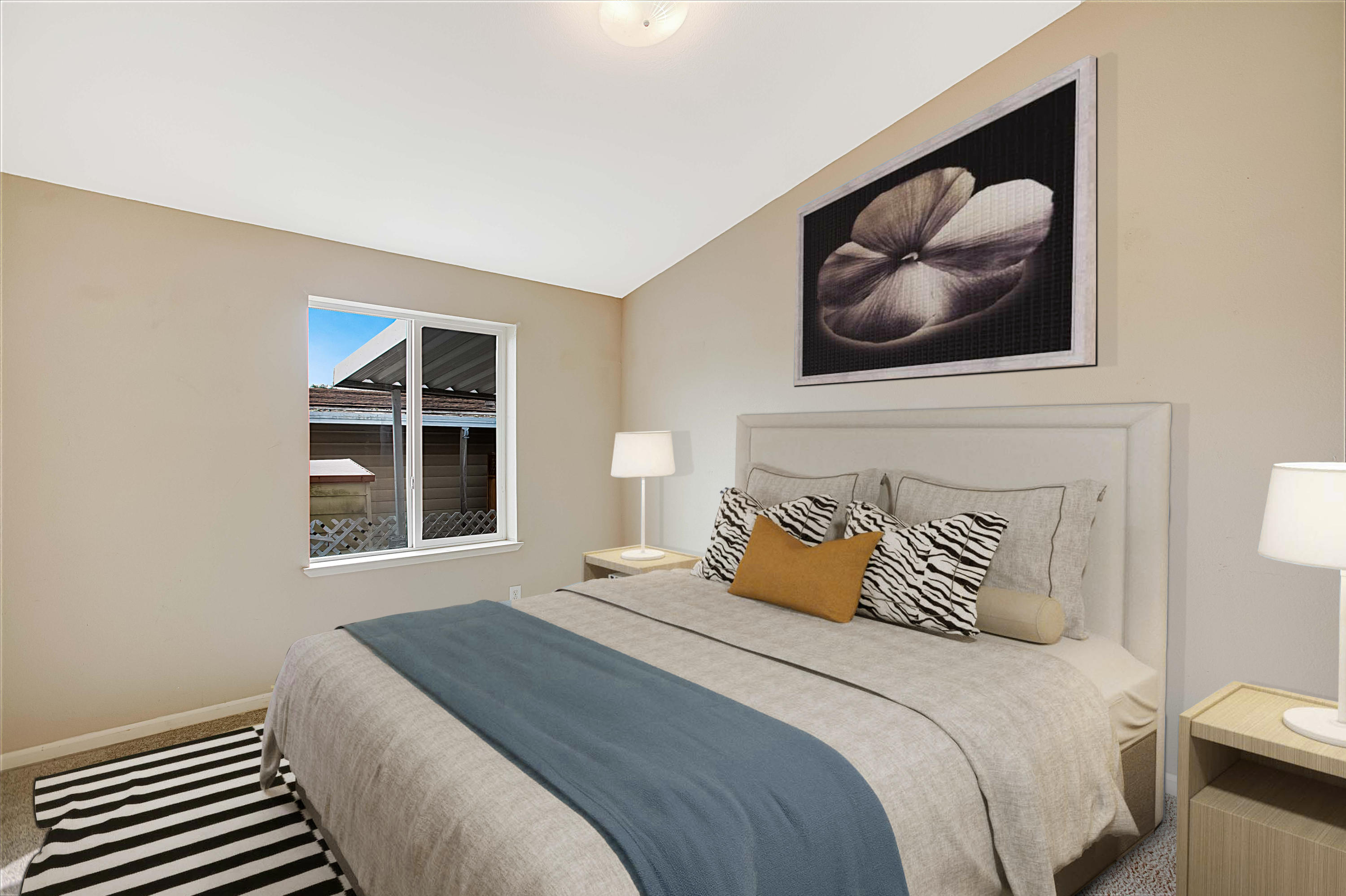 30 Winchester Canyon Road, Unit SPC 111 Goleta, CA 93117 - Photo 13 of 25 a bedroom with a bed and a painting on the wall