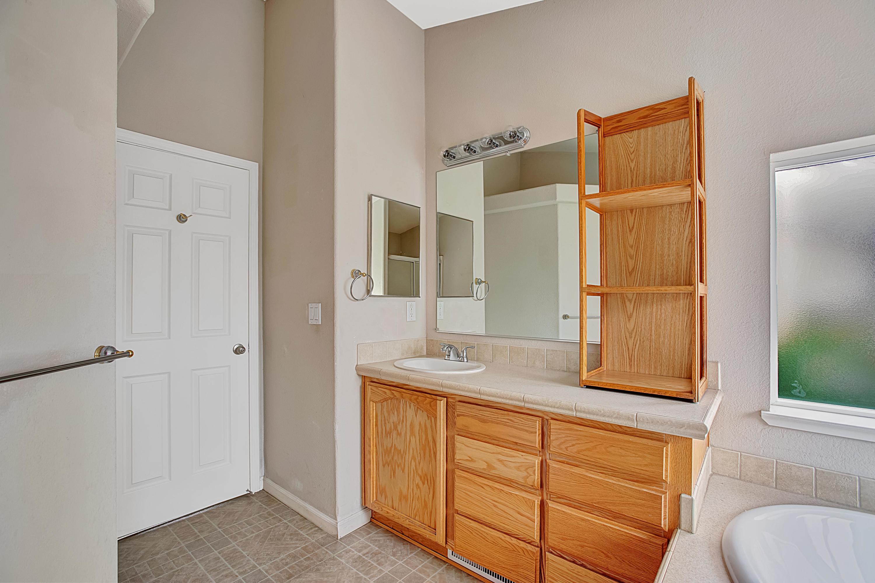 30 Winchester Canyon Road, Unit SPC 111 Goleta, CA 93117 - Photo 16 of 25 a bathroom with a granite countertop sink and a mirror