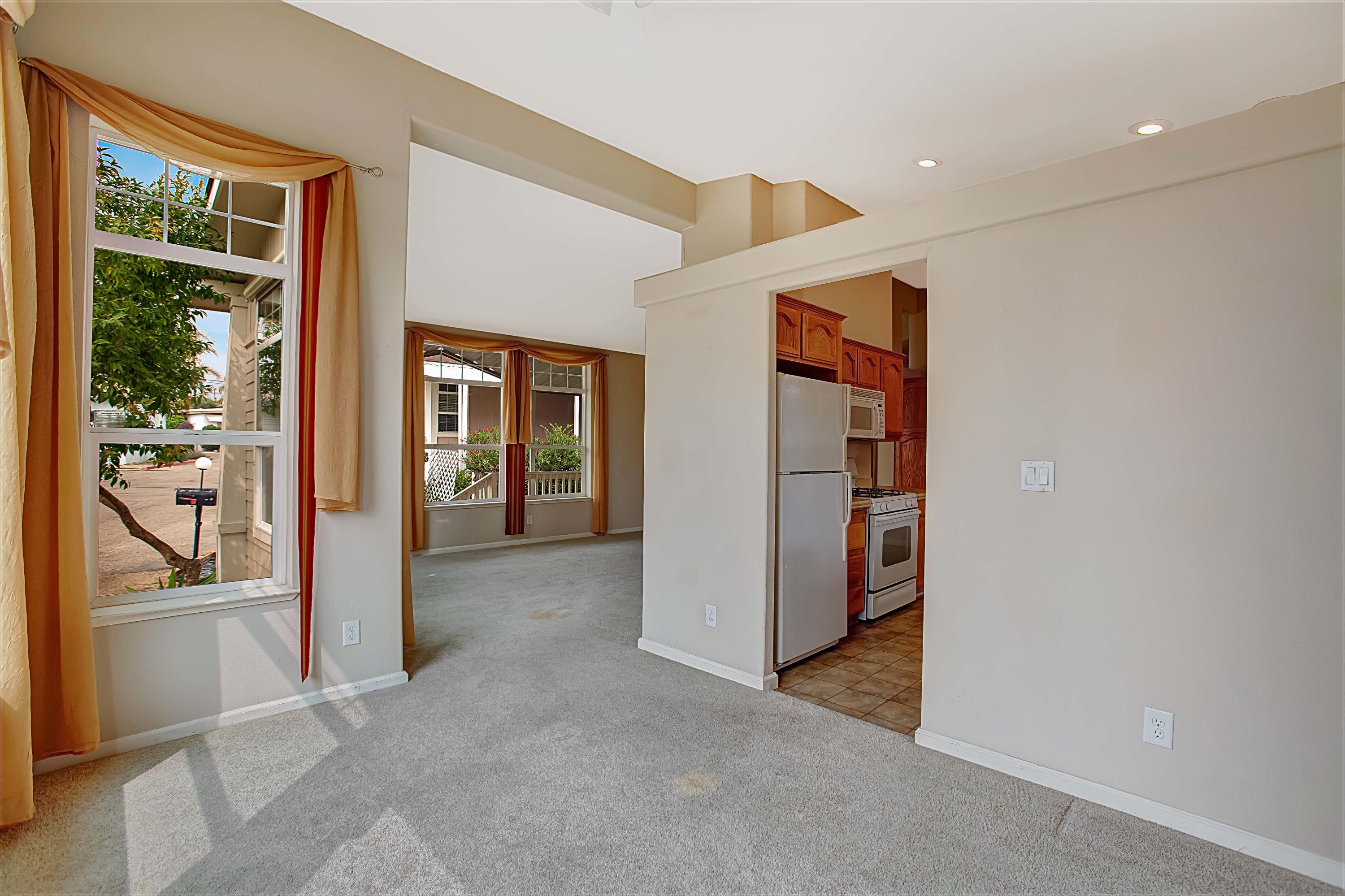 30 Winchester Canyon Road, Unit SPC 111 Goleta, CA 93117 - Photo 7 of 25 hallway with wooden floor and windows