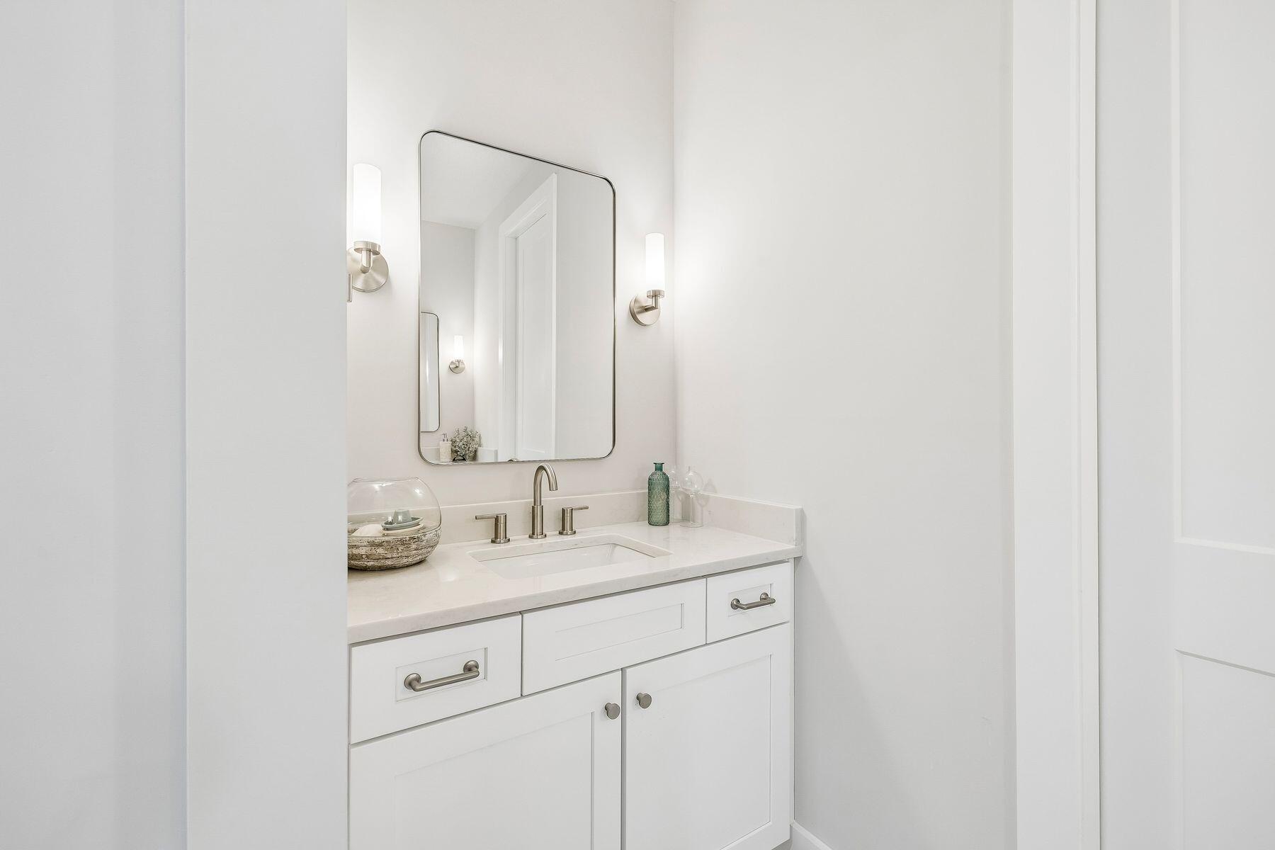 39 West Captain Fritz Way Freeport, FL 32439 - Photo 20 of 33 a bathroom with a double vanity sink and mirror