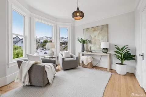 a kitchen with stove and chairs