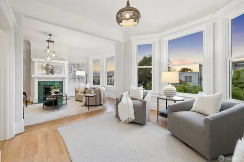 a view of a livingroom with furniture window and wooden floor