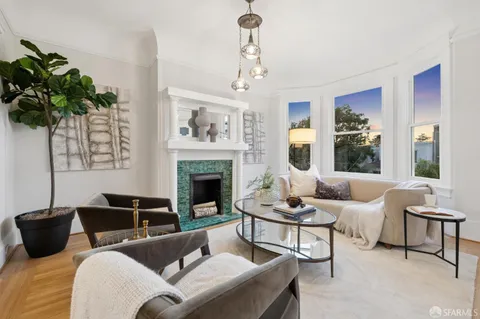 a living room with furniture potted plant and a fireplace