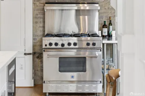 a view of a patio with couches table and chairs and potted plants