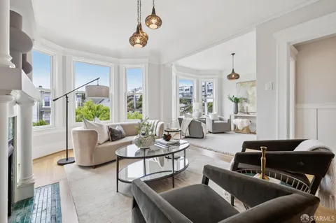 a living room with furniture and a chandelier