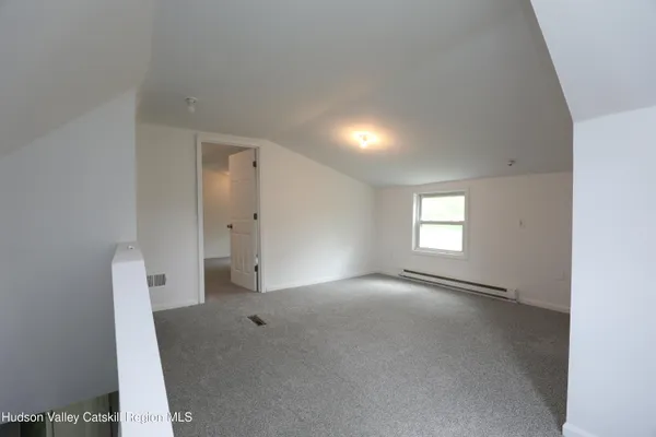 an empty room with a empty space and windows