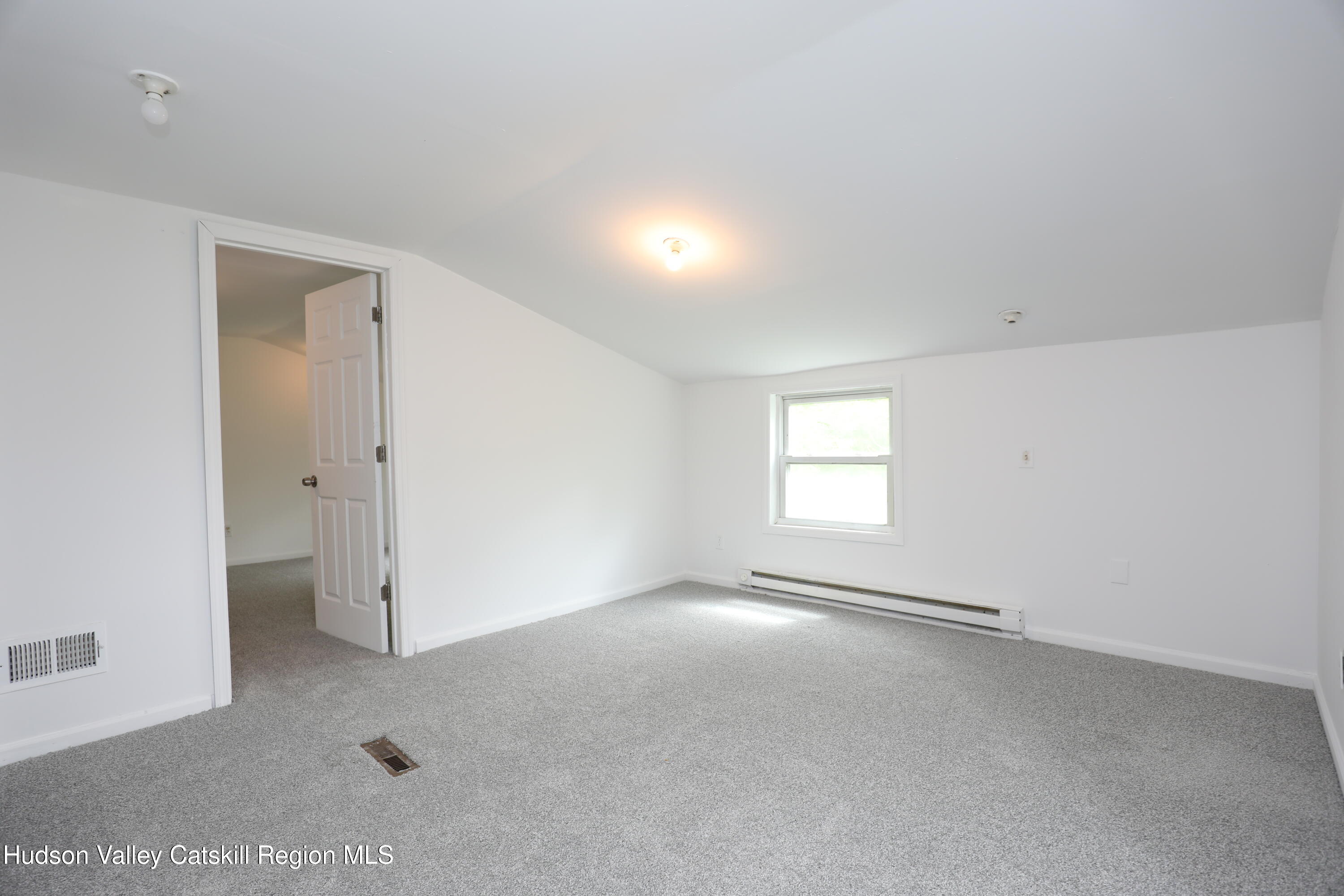 17 Rear Chapel Street, Unit 2 Ellenville, NY 12428 - Photo 14 of 20 an empty room with a empty space and windows