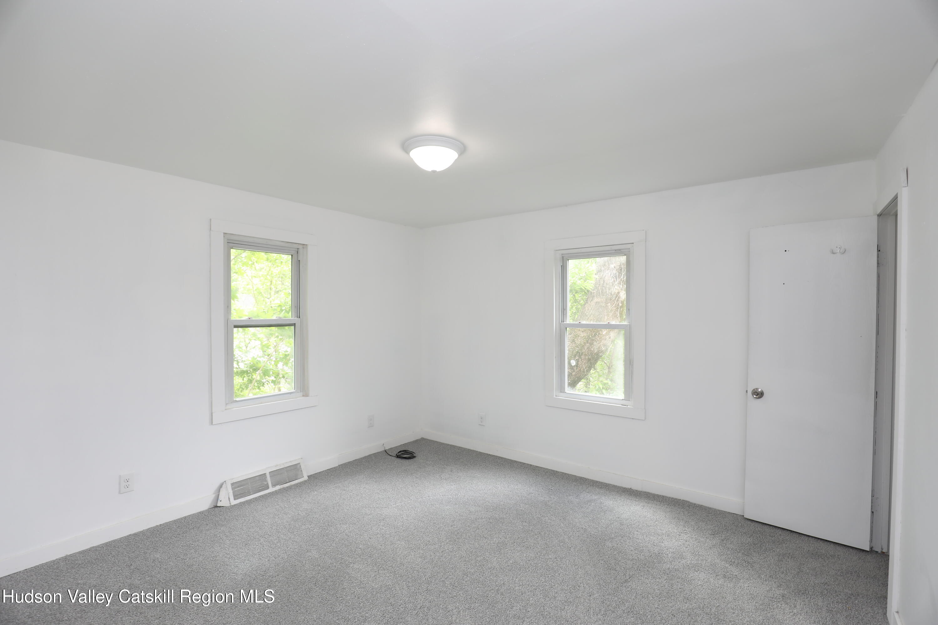 17 Rear Chapel Street, Unit 2 Ellenville, NY 12428 - Photo 8 of 20 an empty room with windows