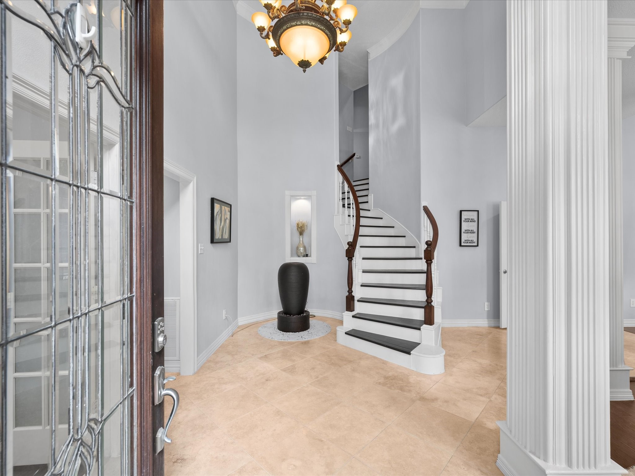 16123 Lafone Drive Spring, TX 77379 - Photo 8 of 47 Step inside to a grand foyer where soaring ceilings, elegant crown molding, stately columns, and a sweeping staircase set the tone for the impressive spaces beyond.