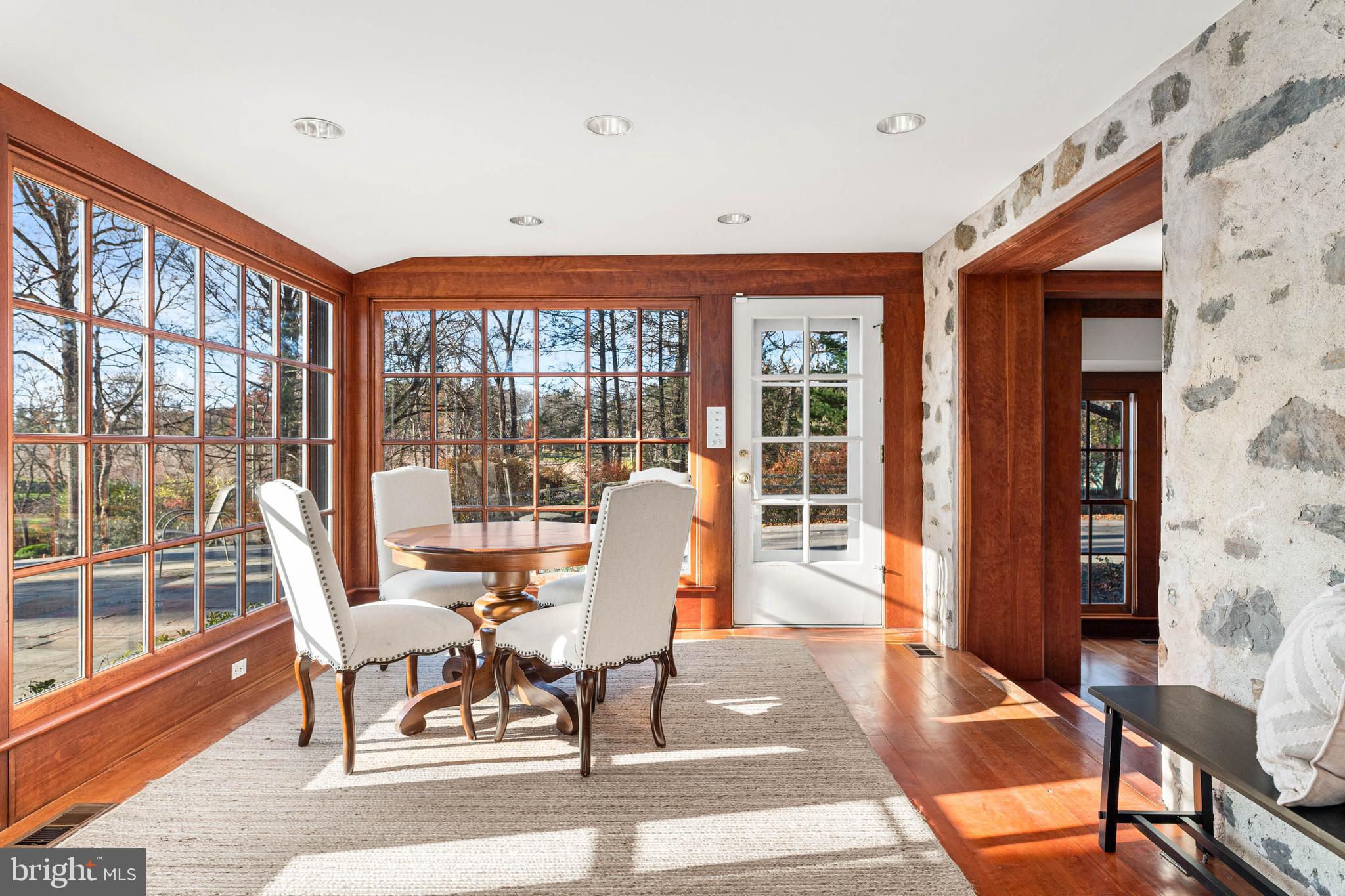 188 Abrahams Lane Villanova, PA 19085 - Photo 30 of 49 a dining room with wooden floor a glass table and chairs